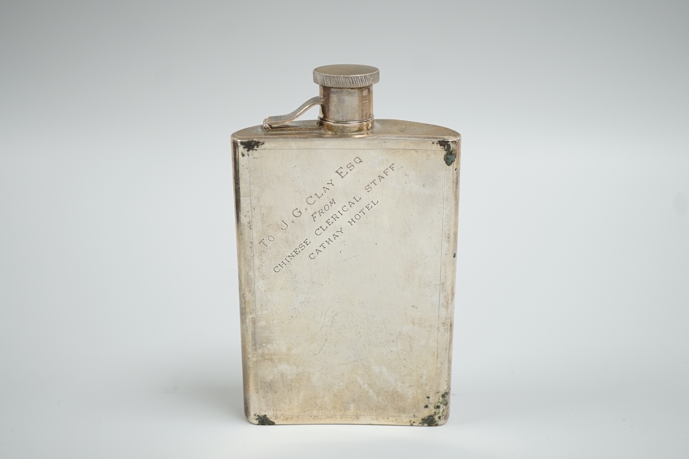 An early 20th century Chinese white metal hip flask, engraved with dragon, inscription and initials, 14.5oz, 6.7oz.